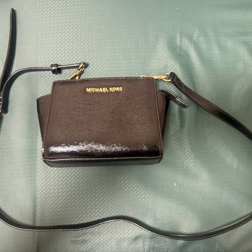 Michael Kors Selma Mini Messenger bag in black patent leather